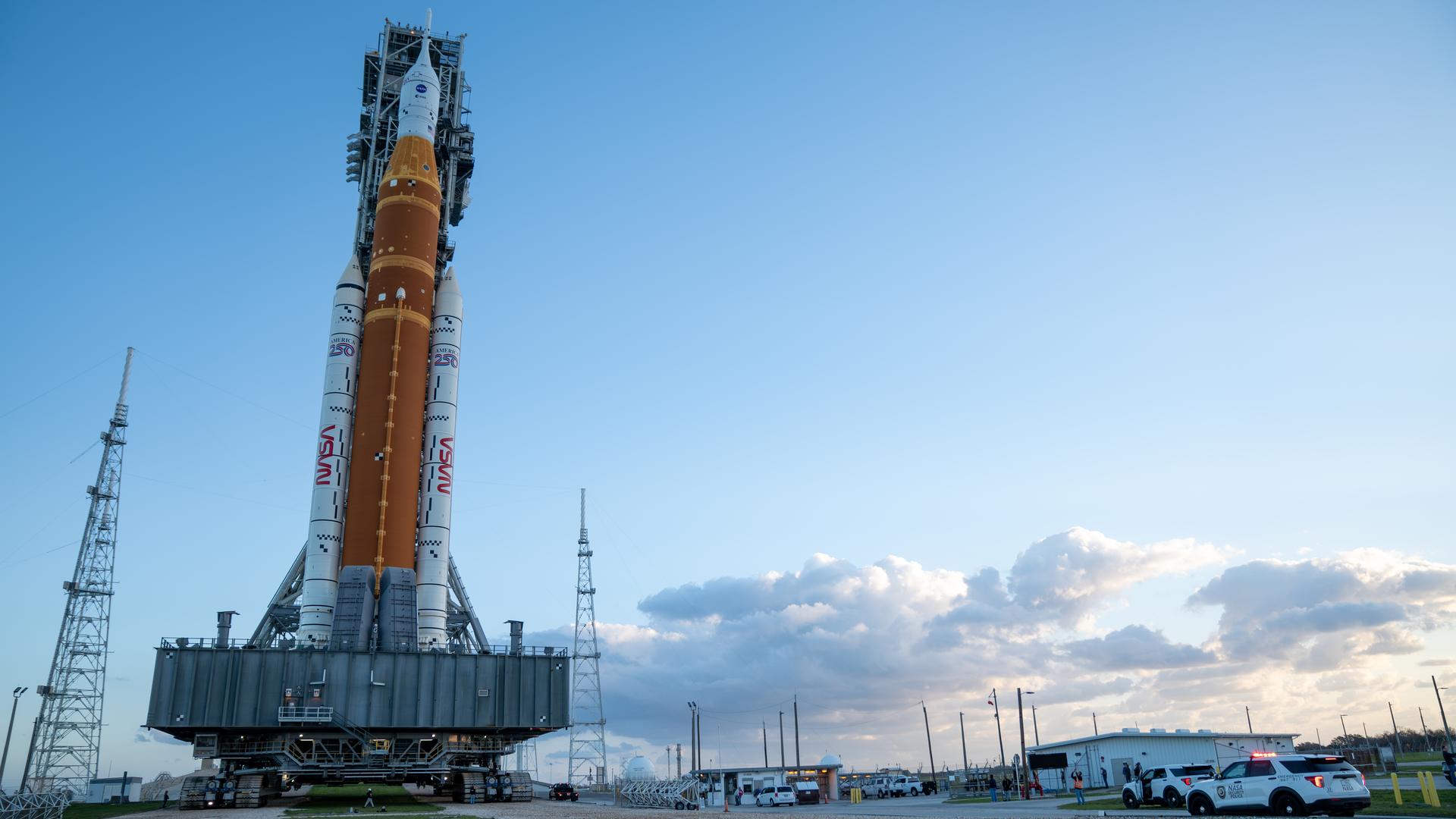 This image shows NASA’s SLS (Space Launch System) and Orion spacecraft rolling out of the Vehicle Assembly Building at NASA’s Kennedy Space Center. NASA's massive Crawler-Transporter, upgraded for the Artemis program, carries the powerful SLS rocket and Orion spacecraft on the Mobile Launcher from the Vehicle Assembly Building to Launch Pad 39B at Kennedy Space Center in preparation for the Artemis II mission. 